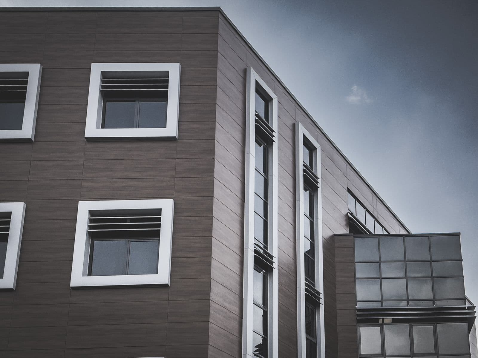 Contemporary apartment facade with large windows and clean geometric lines. Illustrative stock photograph.